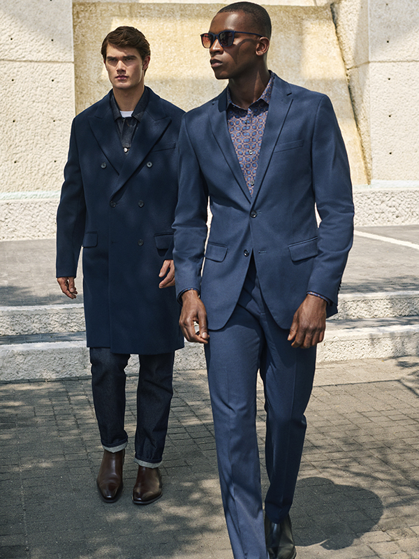 Model in Perry Ellis Suits Collection in Black